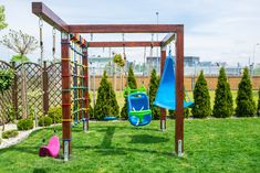 a child's play area with swings, slides and climbing bars in the grass