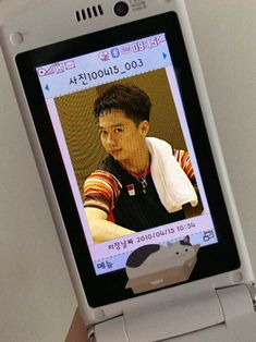 a cell phone with an image of a man on the screen