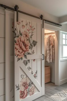 an open barn door with flowers painted on it