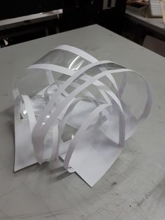 a piece of white paper sitting on top of a table next to scissors and tape