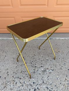 a small table sitting on top of a floor in front of a garage door,