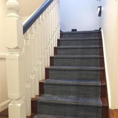 a staircase with carpeted steps and white railings