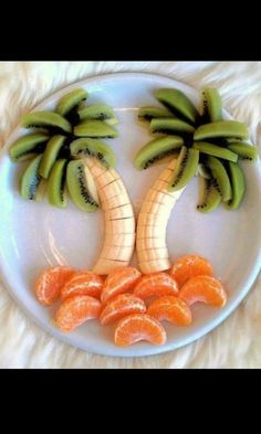 a white plate topped with sliced oranges and banana's on top of each other