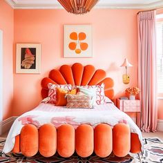 an orange bed in a bedroom with pink walls