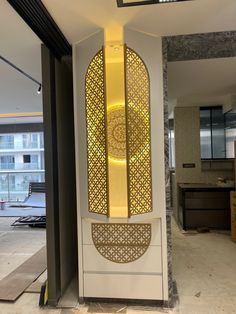 a tall white and gold clock sitting inside of a building