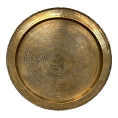 a gold plate with intricate designs on it