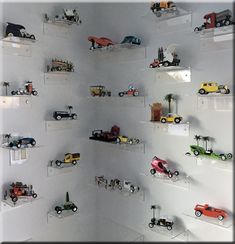 there are many toy cars on the shelves