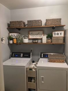 a washer and dryer in a laundry room with shelves above them that hold items