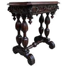 an ornate wooden table with carved legs and carvings on the top, against a white background