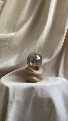 a rock sitting on top of a white cloth