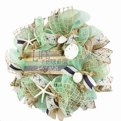 a wreath made out of burlocks and seashells with words written on it