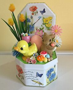 a small box filled with toys and flowers