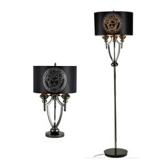 a floor lamp with a black shade and a lion head on the top of it