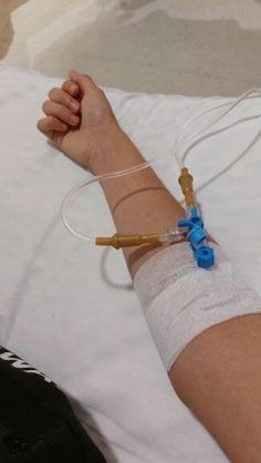 a person laying in bed with an iv attached to their arm