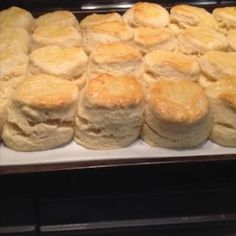 bread rolls are lined up on a baking sheet in the oven and ready to be baked