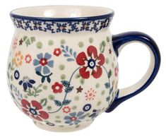 a blue and white coffee cup with flowers painted on the side, sitting in front of a white background