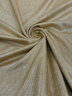 a close up shot of the fabric in gold metallic glitter, which is very soft and shiny