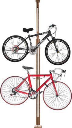 a bike is hanging on the pole with two bicycles attached to it's sides