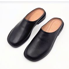 Materials: 100% Genuine Leather Sole: Comfort-contoured Heel: Flat Fit: Snug  Size Chart: For sizing information, please see the size chart included in the picture gallery or use online shoes size converter https://www.gigacalculator.com/converters/shoe-size-converter.php Elevate your style with these sleek Leather Mules for Women: Flat Shoes for Women, Gift for Women  The modern square-toe design adds a touch of sophistication, while the smooth leather construction ensures comfort and quality. Black Leather Slip-on Mules, Business Mules With Leather Sole And Round Toe, Business Mules With Round Toe And Leather Sole, Black Mules With Stitched Sole And Round Toe, Black Leather Mules With Stitched Sole, Formal Black Slip-on Clogs, Black Leather Clogs With Stitched Sole, Black Slip-on Mules With Stitched Sole, Classic Slip-on Mules With Round Toe