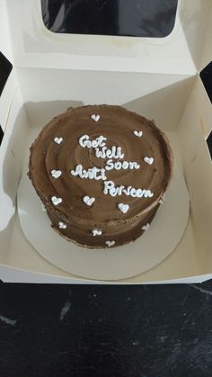 a chocolate cake with white hearts in a box