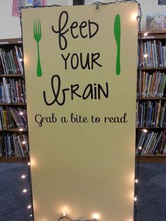 a sign that reads feed your brain grab a bite to read with forks and spoons