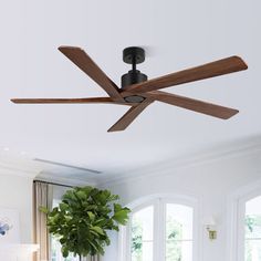 a living room with a couch and a ceiling fan in it's centerpiece