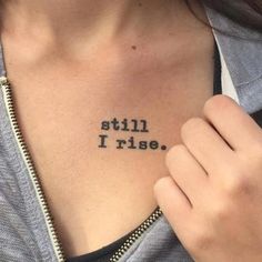 a woman with a tattoo that says still i rise on her chest and the words written in cursive font