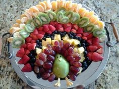 a platter filled with fruits and vegetables that says vegan thanksgiving fruit arrangement on it