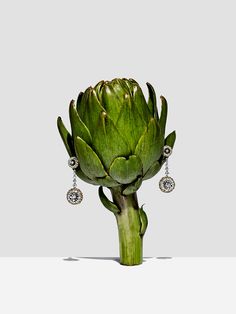 an artichoke is shown with earrings on it