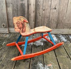 an old wooden rocking toy with a horse painted on it