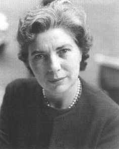 an old black and white photo of a woman with pearls on her necklace, looking at the camera