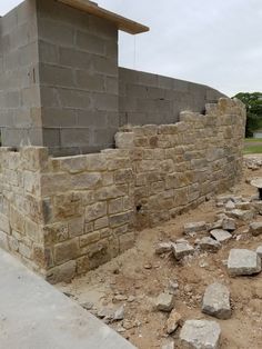 a brick wall is being built on the side of a building