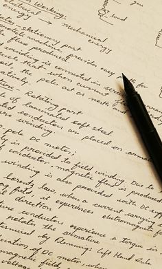 a pen sitting on top of a piece of paper next to an old fashioned handwritten letter