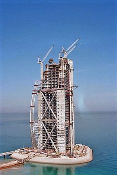 a very tall building under construction in the middle of the ocean