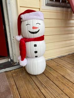 an inflatable snowman is standing on the porch