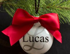 a personalized ornament hanging from a christmas tree