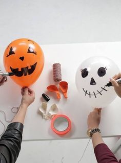 someone is decorating a balloon for halloween