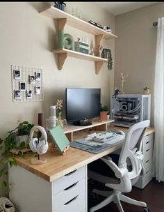 a desk with a computer and headphones on it