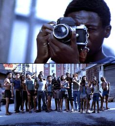 a group of people standing in front of a building taking pictures with an old camera