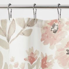 a shower curtain with pink and gray flowers hanging from it's metal rod ends