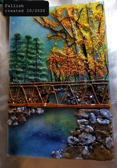 a painting with trees and rocks in the background, along with a bridge over water