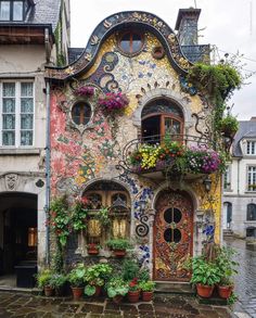 a colorful house with lots of windows and flowers