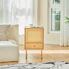 a living room with a white couch and wooden side table