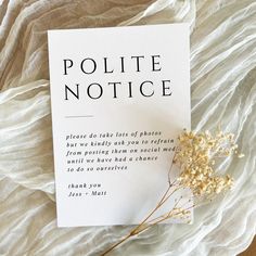 a piece of paper that says polite notice next to some flowers on a white sheet