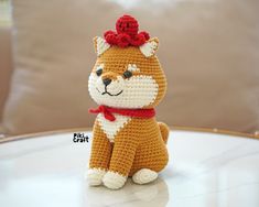 a small crocheted dog sitting on top of a table