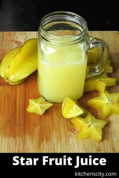 a glass jar filled with liquid next to star shaped fruit