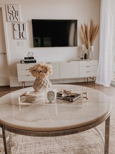 a living room with a coffee table and television