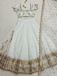 Ivory Designer Fully Customised Lehenga Choli Specification Lehenga Lehenga Fabric : Banarasi Gerogette silk Lehenga Closer: Drawstring, Attached Tussle  Flair: 3.5 Meter Inner: Cotton Skirt Style: Customized  Blouse Blouse Fabric: Raw Silk Blouse Work: Sequins, Kasab, Zardosi Blouse Neck: Fully Customized  Dupatta Dupatta Finish Type: Heavy Lace, Sequins, Kasab, Zardosi Dupatta Fabric: Soft Net Package Contain: Lehenga, Blouse and Dupatta, Drawstring, Tussle  Our products are 100% authentic and Elegant Off-white Lehenga For Festive Occasions, Cream Dress With Cutdana For Diwali, Elegant Cream Lehenga For Navratri, Cream Dress For Navratri Reception, Off White Floor-length Gown With Dupatta, Festive Off White Sharara For Reception, Festive Beige Cutdana Dress, Cream Dress With Dupatta For Navratri, Cream Floor-length Dress For Navratri