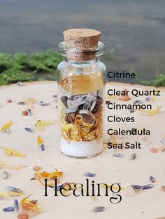 Healing spell jar photo with labels of what is inside- Citrine, clear quartz, Cinnamon, cloves, calendula, sea salt Healing Jar Witchcraft, Serenity Spell Jar, Spell Jar Gift Ideas, Solar Eclipse Spell Jar, Peace Of Mind Spell Jar, Healing Spells For Others Health Jar, Beginner Witch Spell Jars, Spell Jars Witchcraft Aesthetic