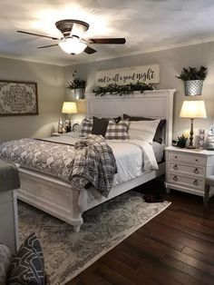 a bedroom with a bed, chair and ceiling fan